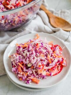 Coleslaw recipe on two stacked plates.