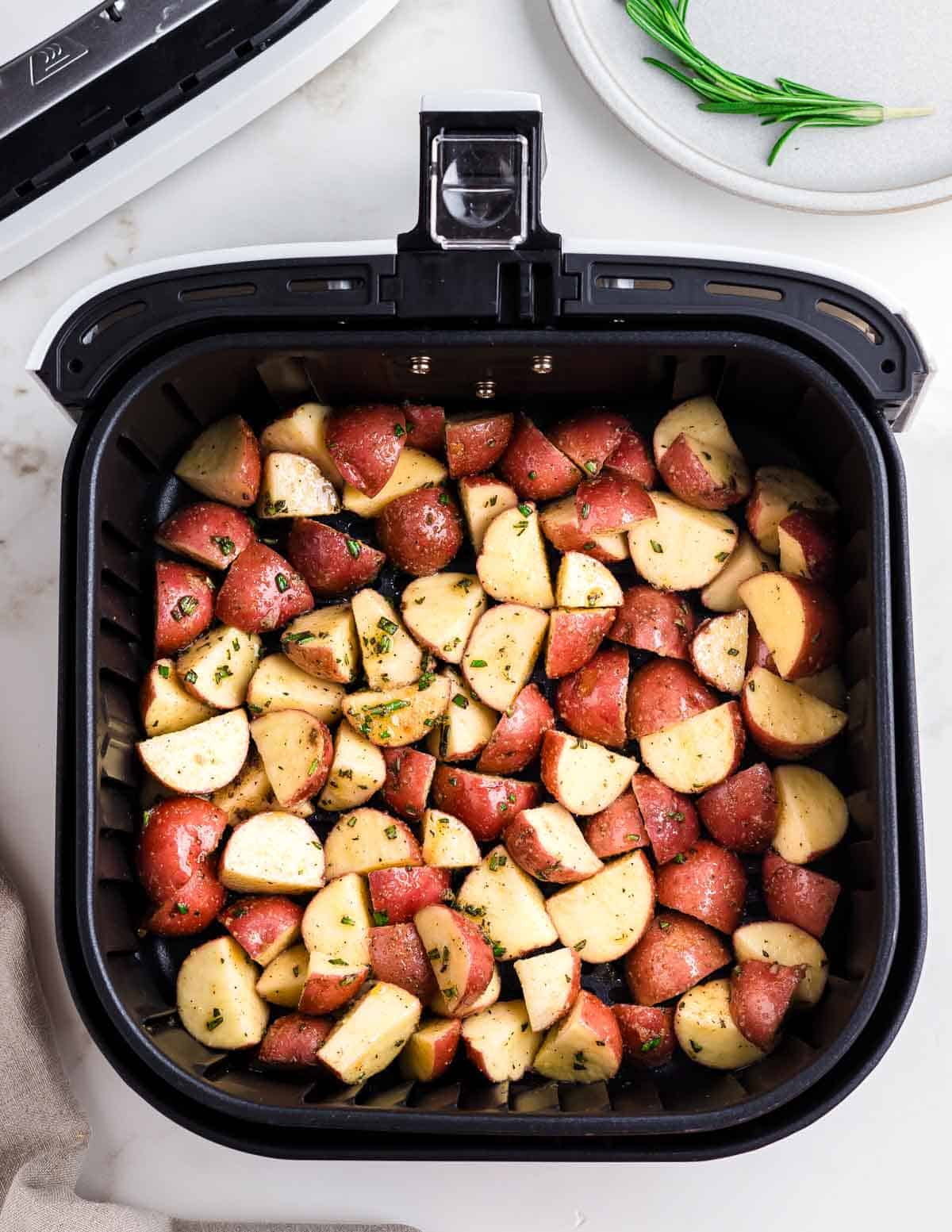 Red potatoes in an air fryer.