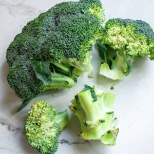 A head of broccoli with large florets broken off.