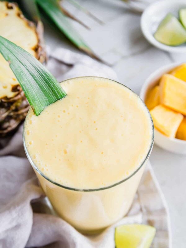 Close up of 3 ingredient mango pineapple smoothie in a glass.