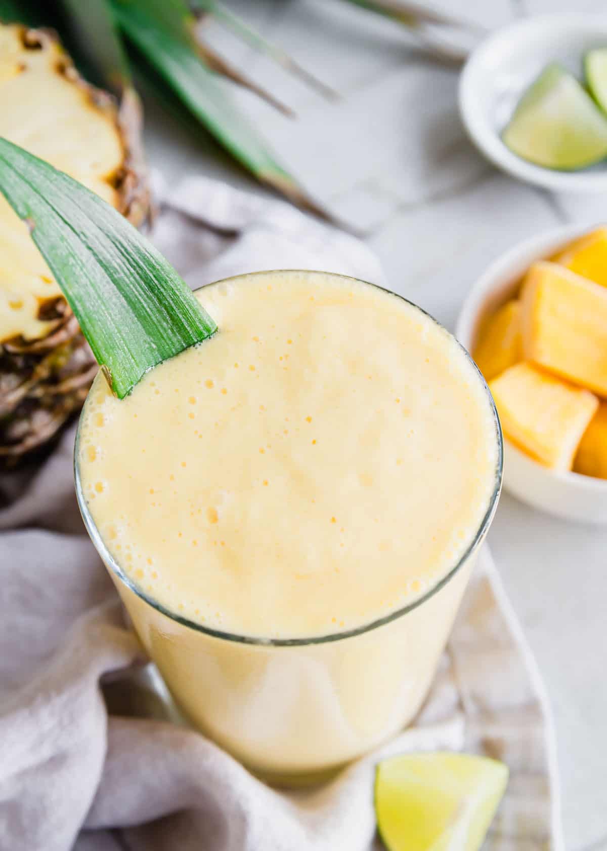 Close up of 3 ingredient mango pineapple smoothie in a glass.
