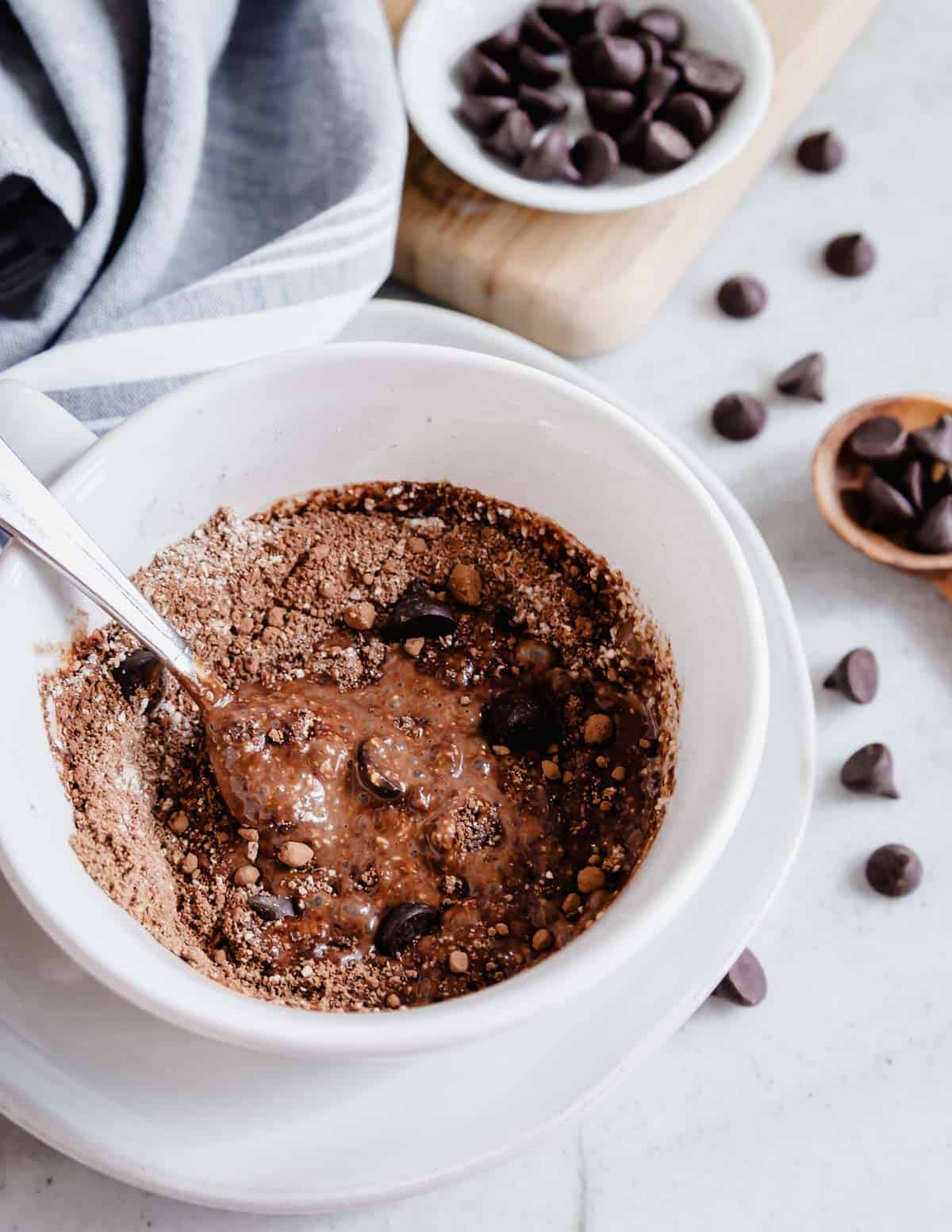 Mixing protein mug cake ingredients in a white mug.