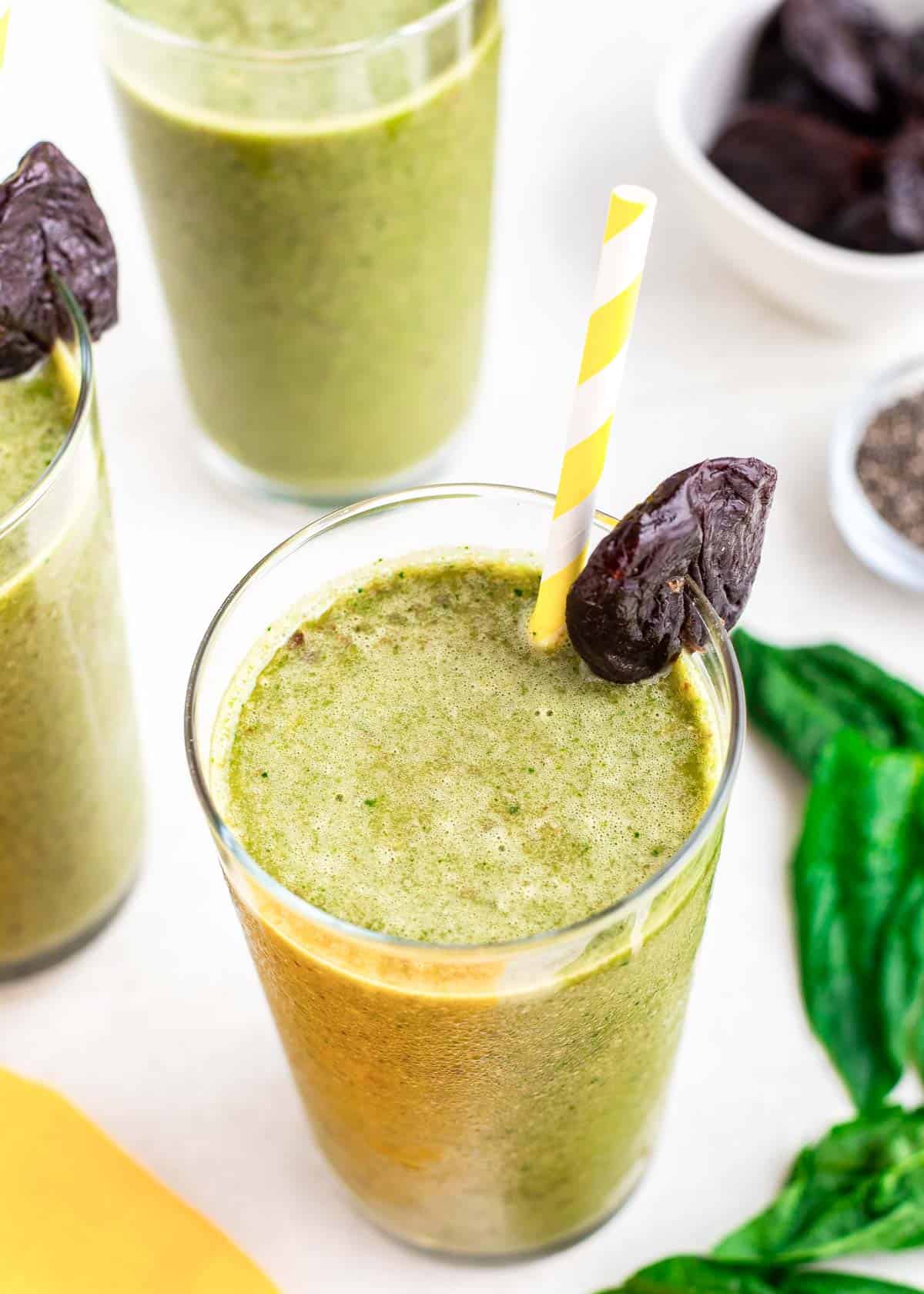 Prune smoothie with prune garnish on the rim of the glass.