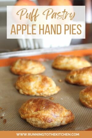 Apple hand pies on a baking sheet.