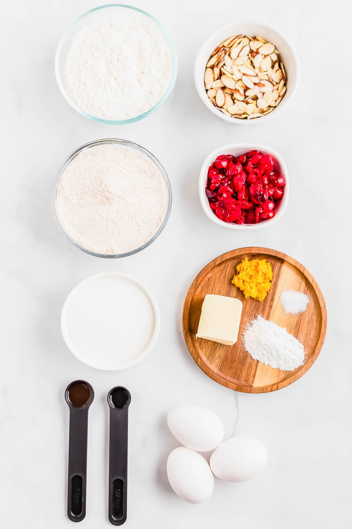 Ingredients in bowls and plates to make cranberry biscotti.