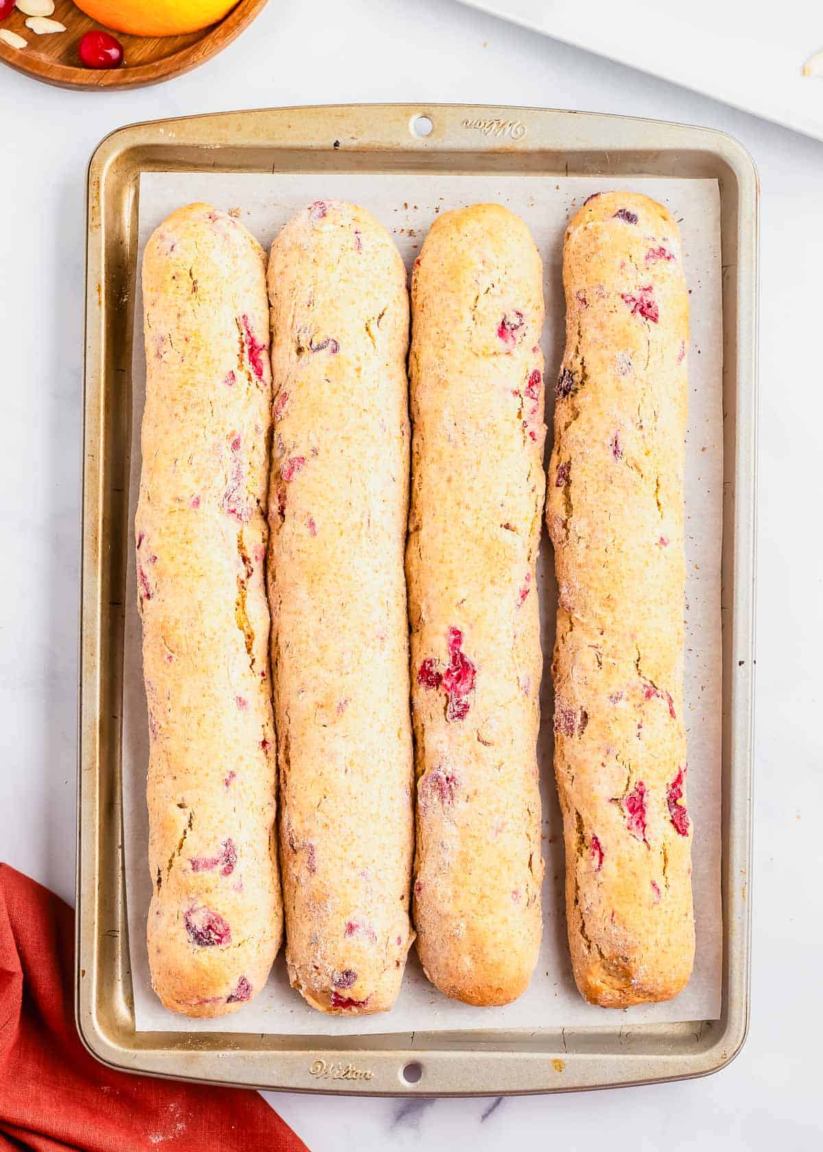 Orange cranberry biscotti after the first bake on a baking sheet.