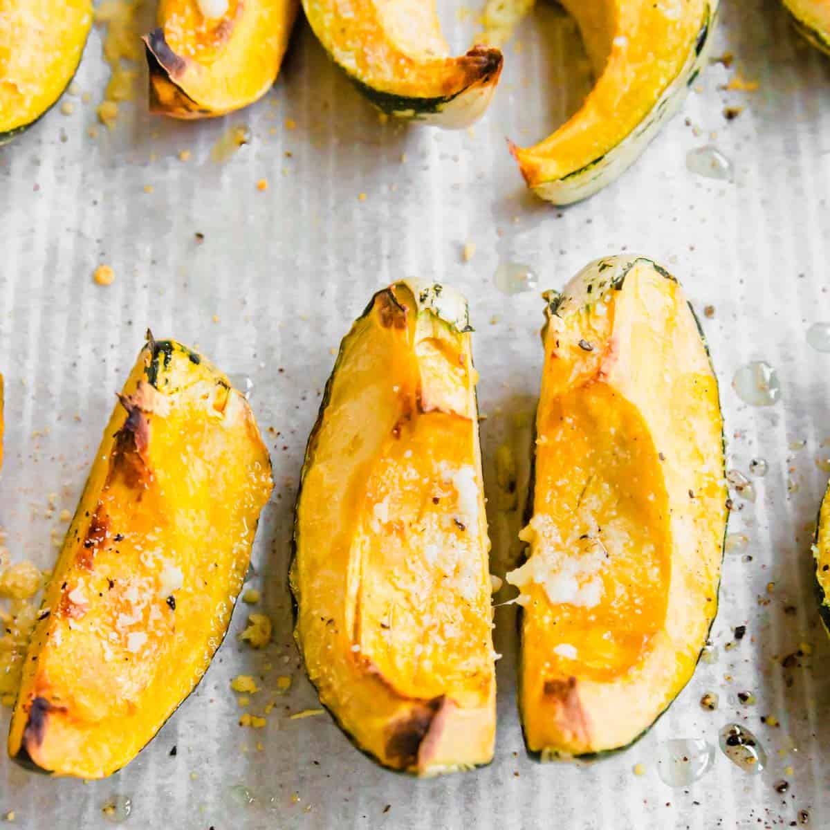 Close up of roasted carnival squash on a baking sheet.