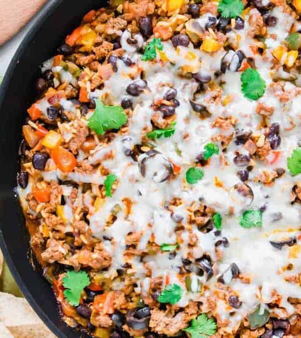 Mexican ground beef in a skillet with tortilla chips.