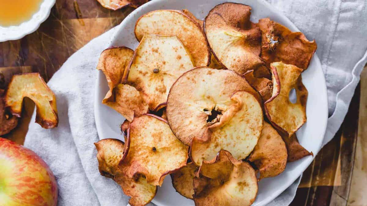 Air fryer apple chips on a plate.