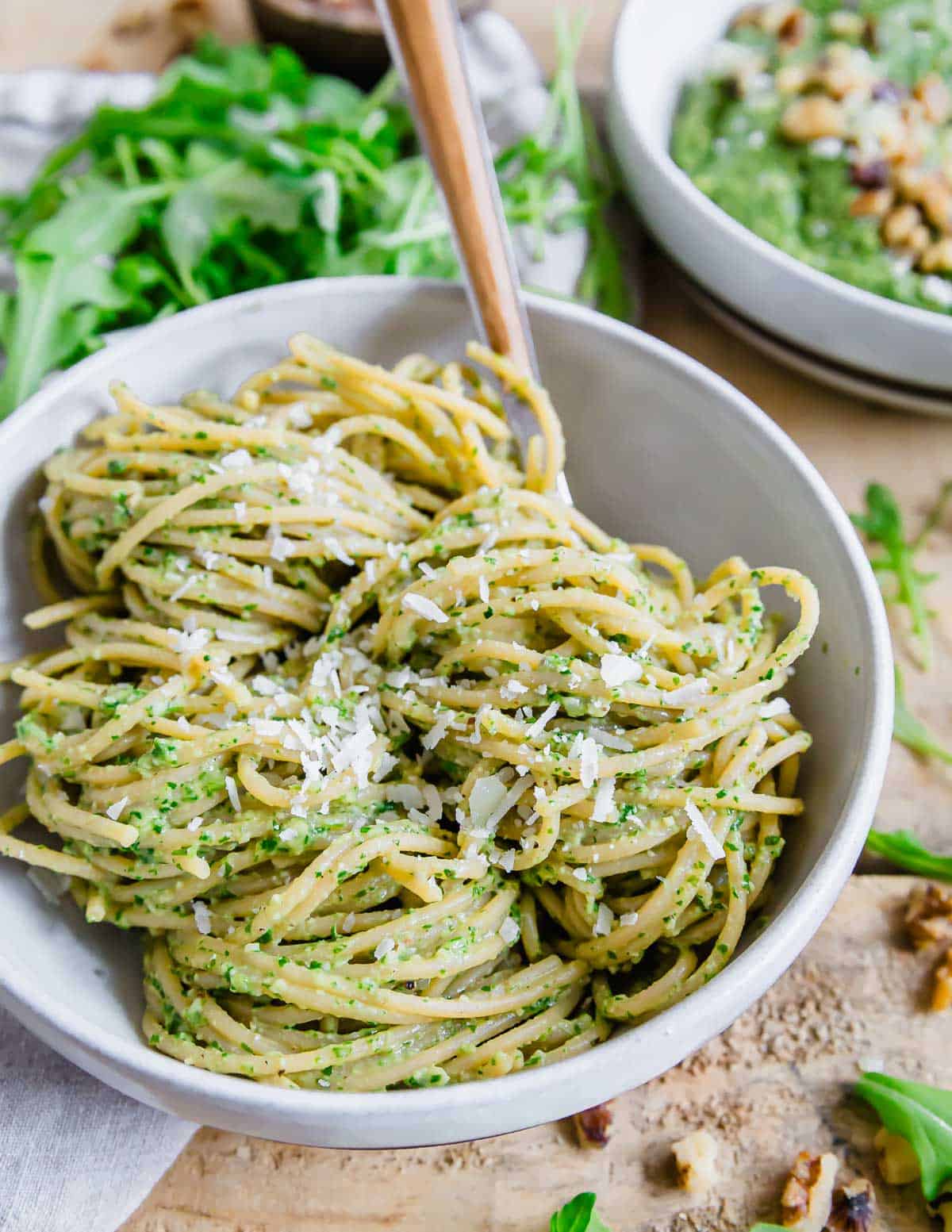 Arugula pesto pasta with walnuts and parmesan cheese.