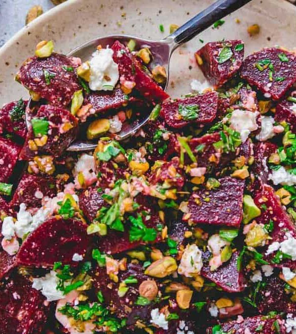 Beet salad with feta and pistachios on a plate.