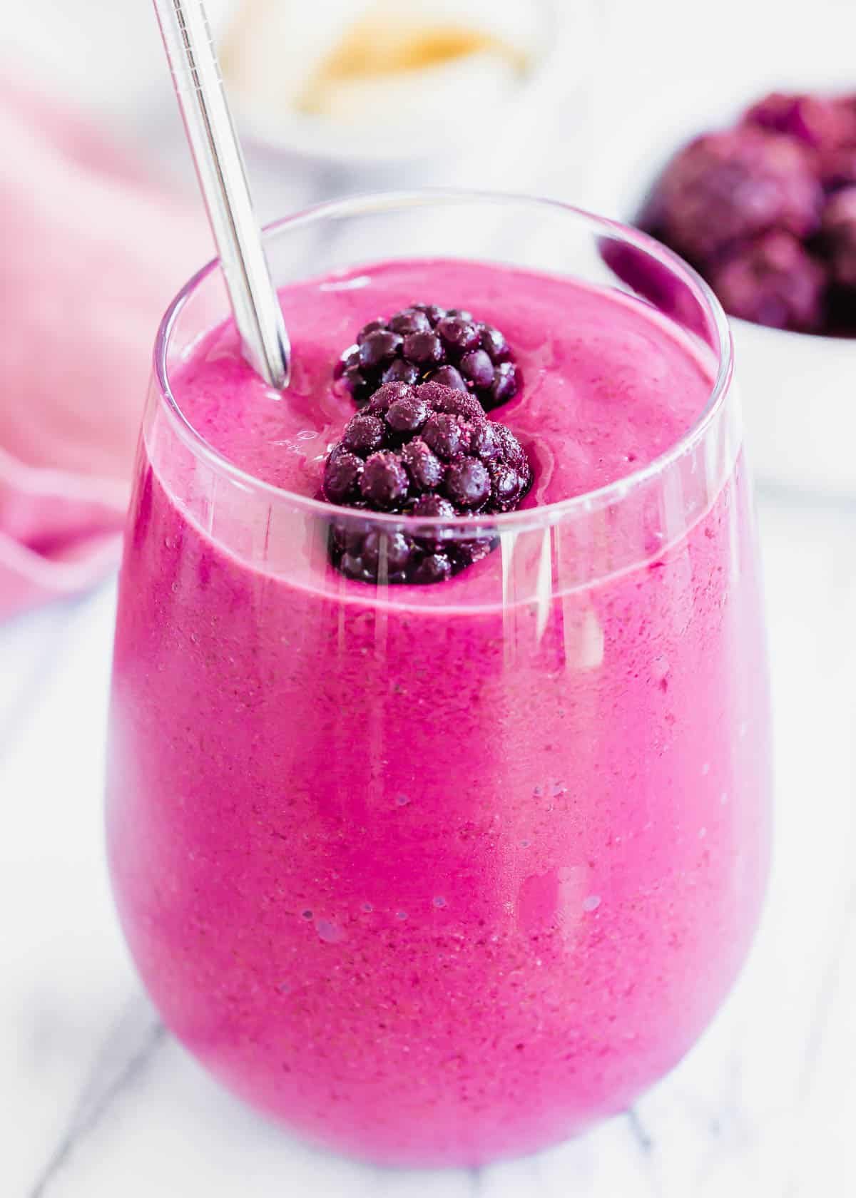 A smoothie with blackberries and bananas in a glass.