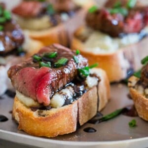 A plate of appetizers with steak and blue cheese.