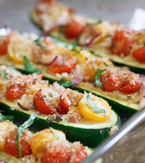 Stuffed zucchini boats with tomatoes and basil.