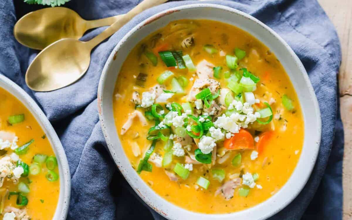 Two bowls of buffalo chicken soup on a table.