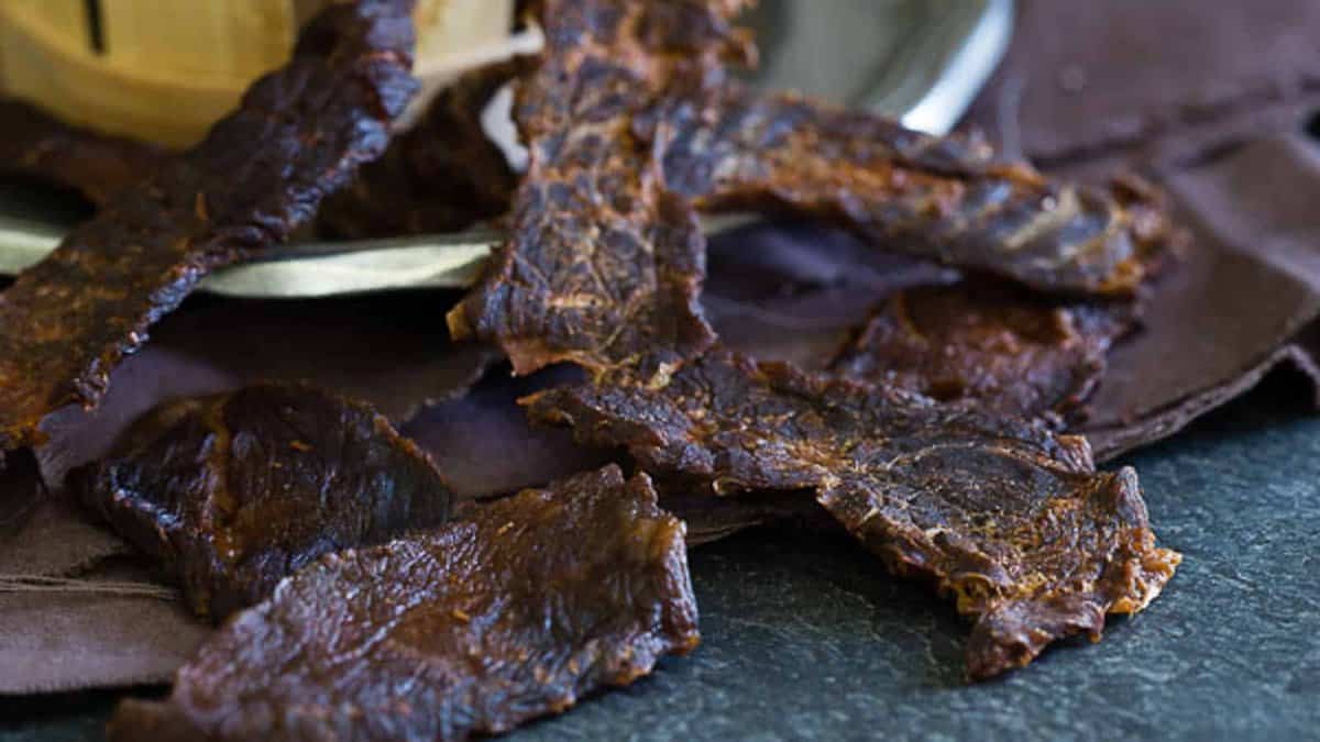 Buffalo sauce beef jerky on a dark background.