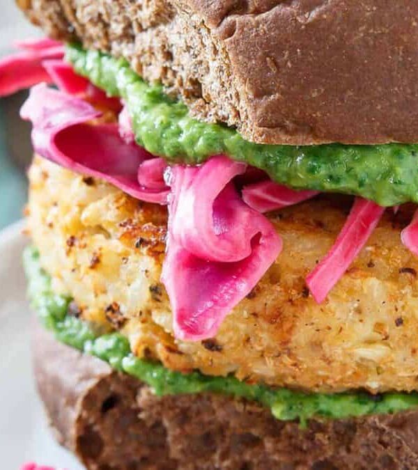 A cauliflower burger with pesto on top.