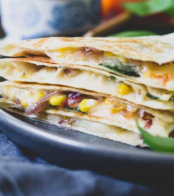 A stack of quesadillas on a plate.