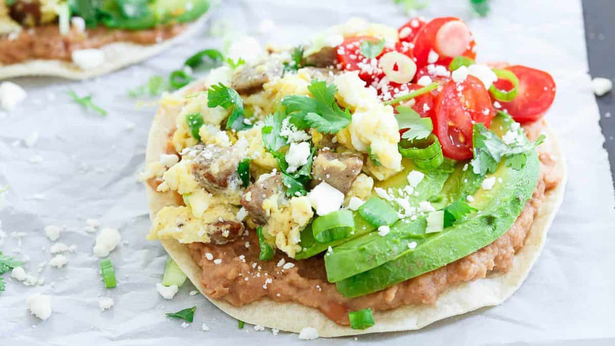 Chicken sausage breakfast tostadas with on parchment paper.