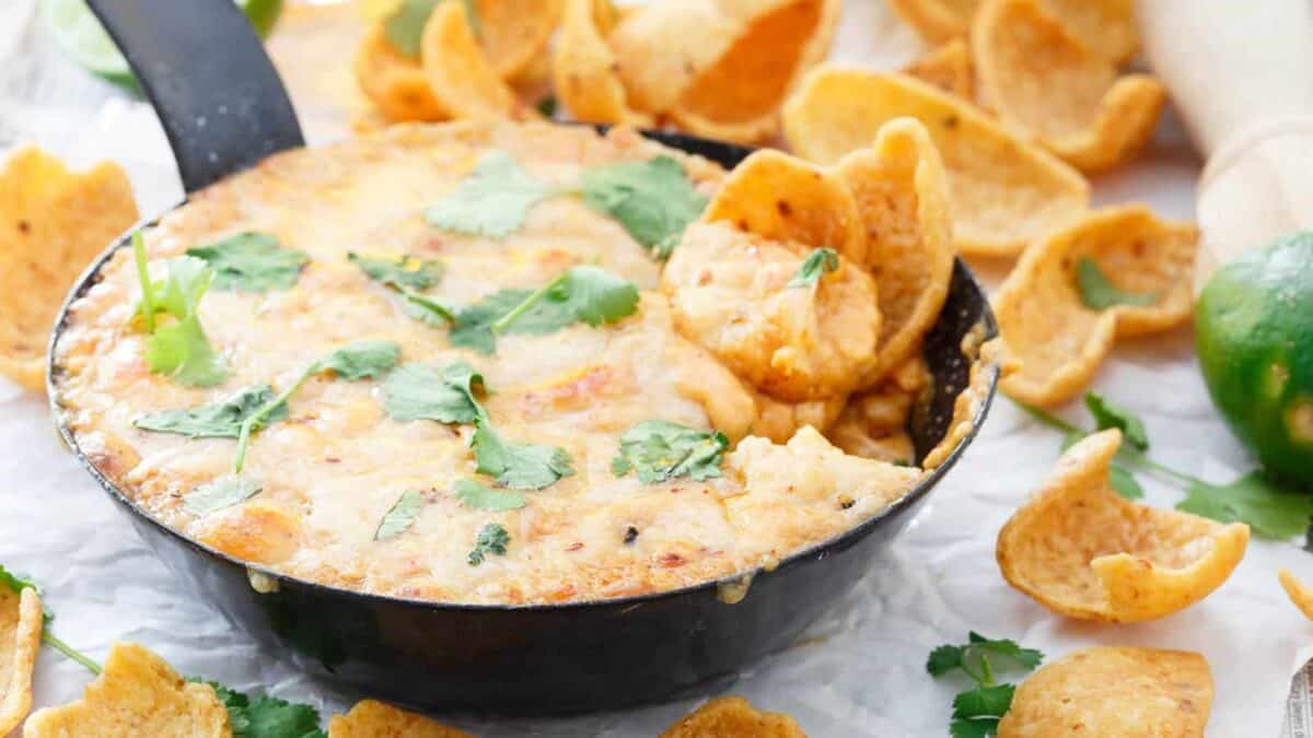 Mexican dip in a black skillet with tortilla chips.
