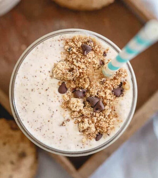 A smoothie with granola and chocolate chips on a tray.