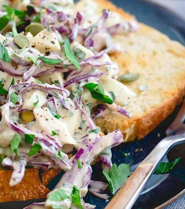 Egg salad on toasted bread with a fork.