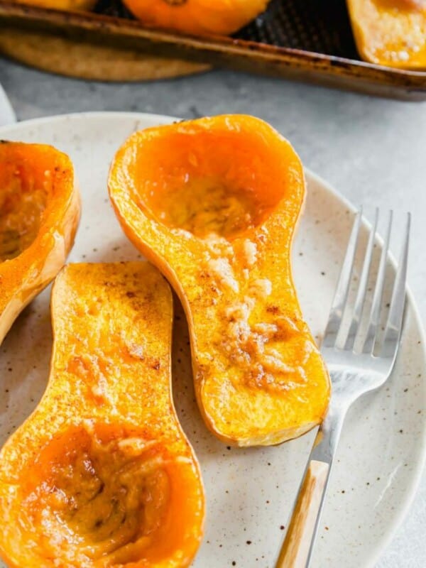 Roasted butternut squash on a plate with a fork.