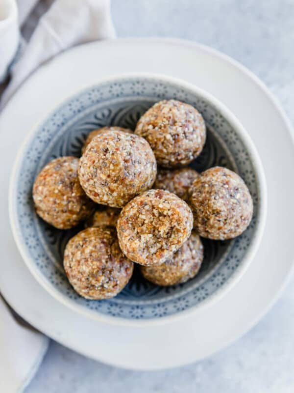 A bowl of granola balls on a white plate.