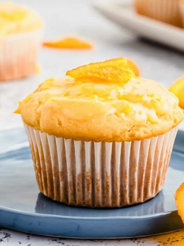 A blue plate with orange muffins on it.
