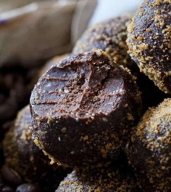 A bowl full of chocolate coffee bites.