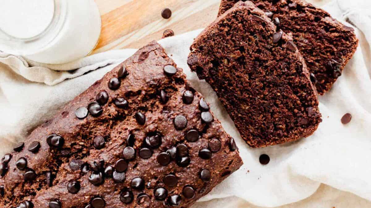 A slice of chocolate chip bread on a wooden table.