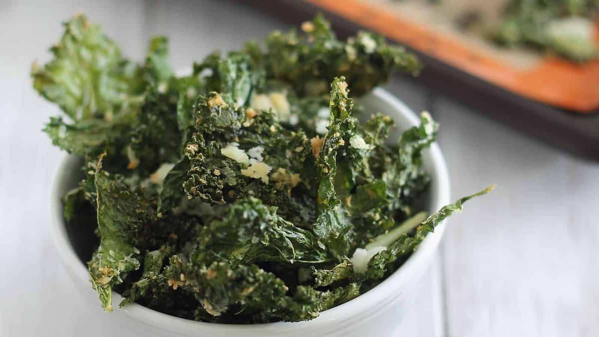 Garlicky kale chips in a small white bowl.