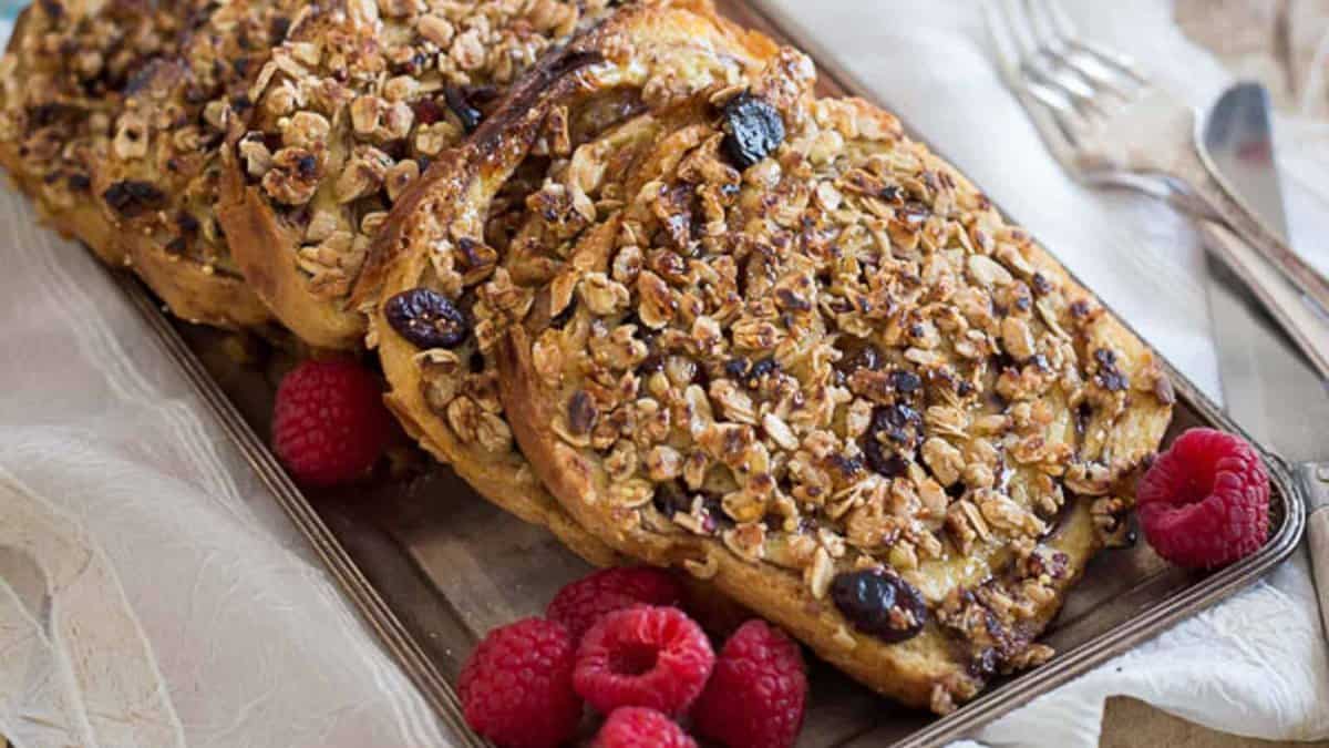 Granola French toast with raspberries on a platter.
