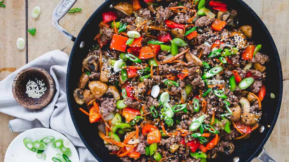 Ground beef stir fry in a skillet.