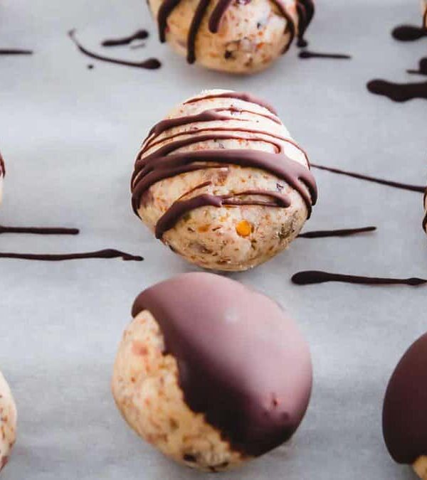 Chocolate covered cookie dough bites on a baking sheet.