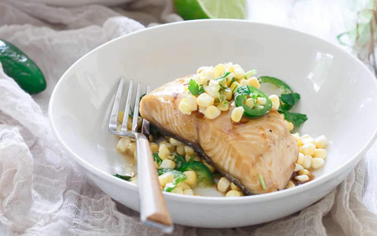 Honey lime sablefish with jalapeño corn salsa in a bowl with a fork.