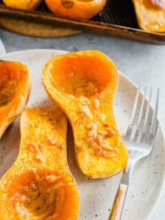 Roasted honey patch squash with miso butter on a plate with a fork.