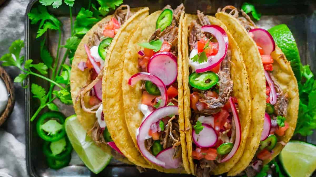 Lamb tacos with radishes, red onions, onions and sliced green chiles.