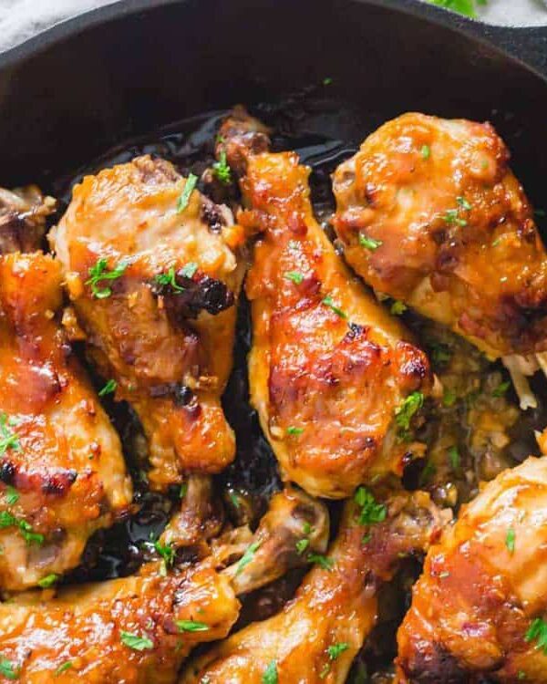 Chicken legs in a cast iron skillet.