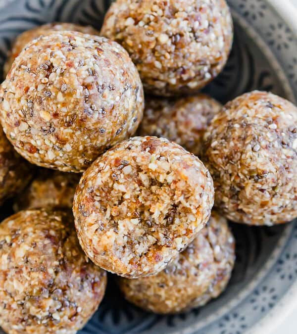 A bowl of granola balls on a table.