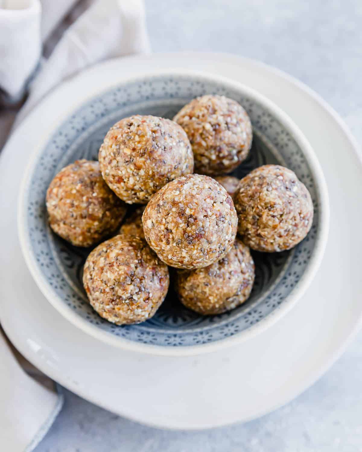 Almond date energy balls in a bowl.