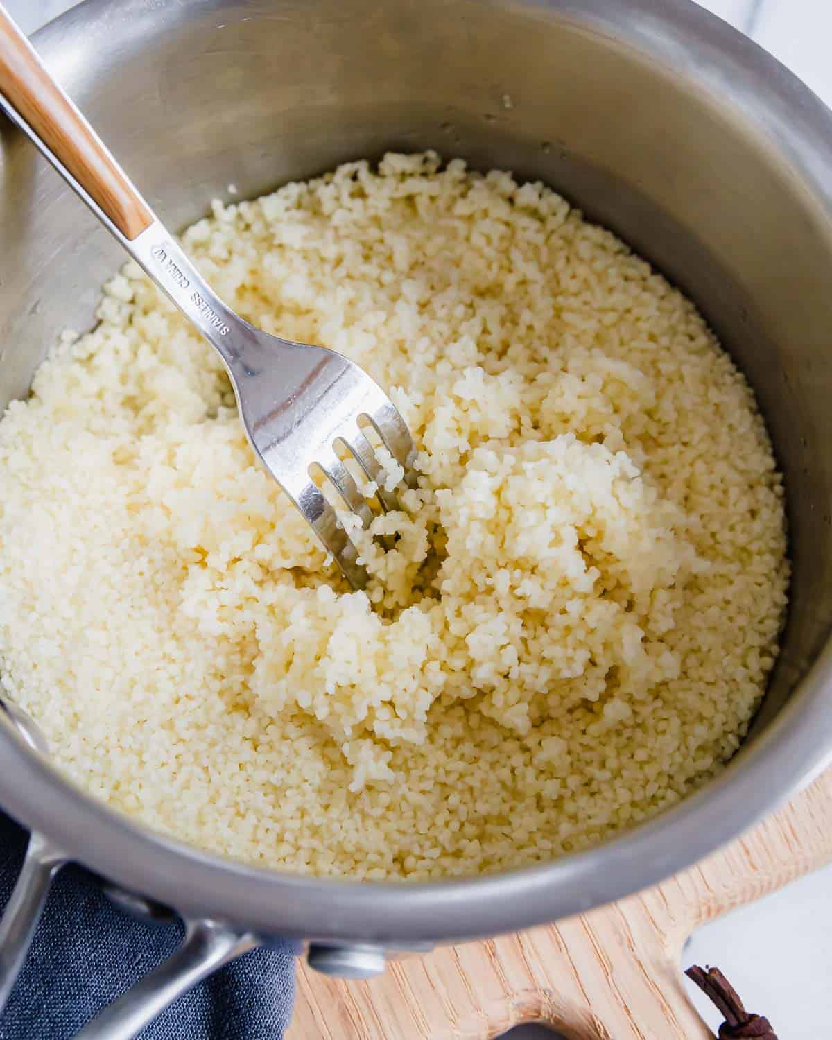 Couscous in a pot with a fork.