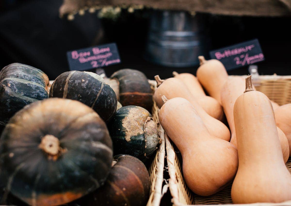 A display of winter squash at a farmers' market.