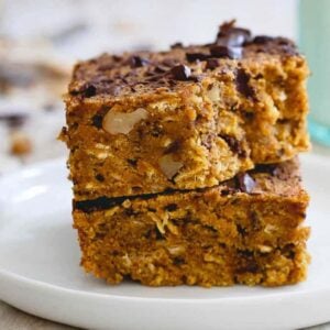 A stack of pumpkin chocolate chip bars on a white plate.