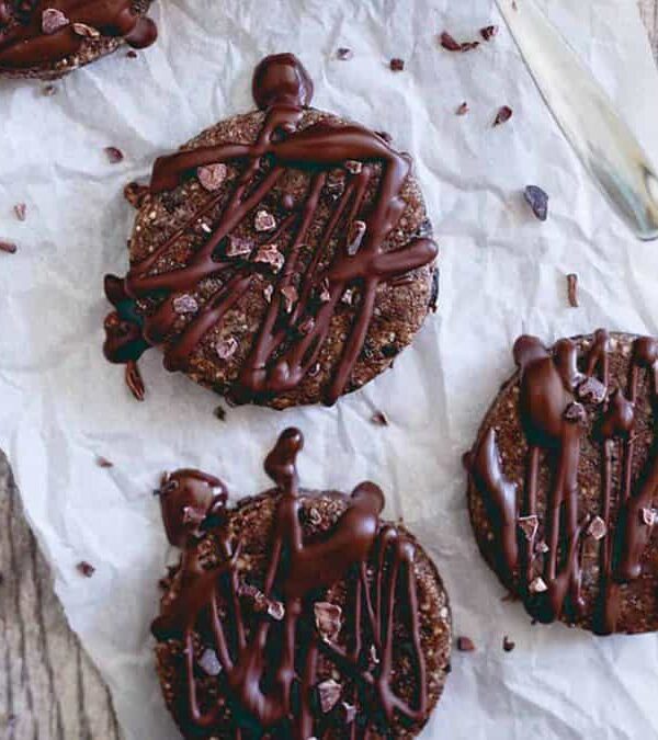 A plate of brownie bites on a wooden table.