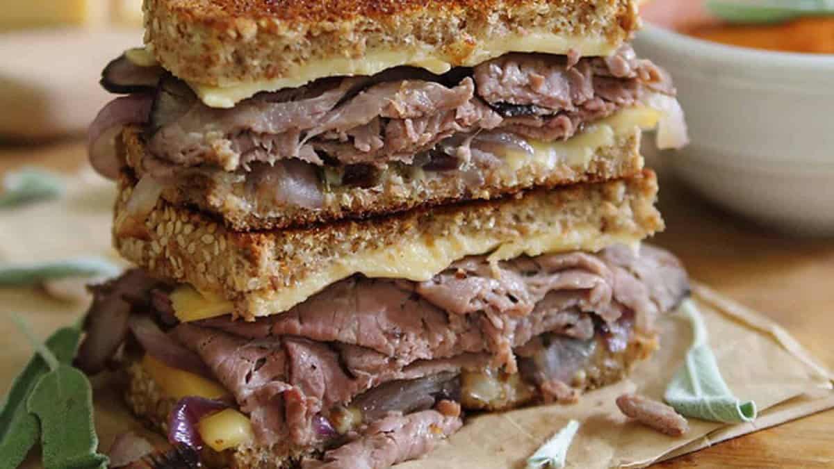 Smoked gouda roast beef grilled cheese cut in half and stacked.
