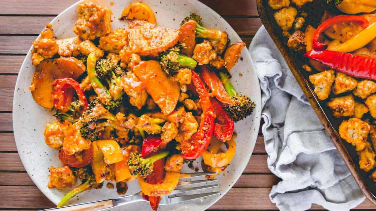 Sheet pan tofu and vegetables with BBQ sauce on a plate.