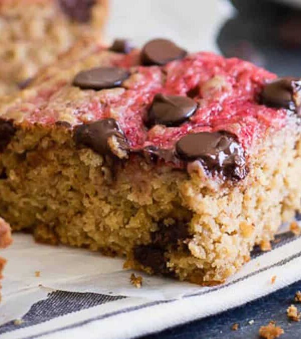 A slice of chocolate strawberry cake on a napkin.