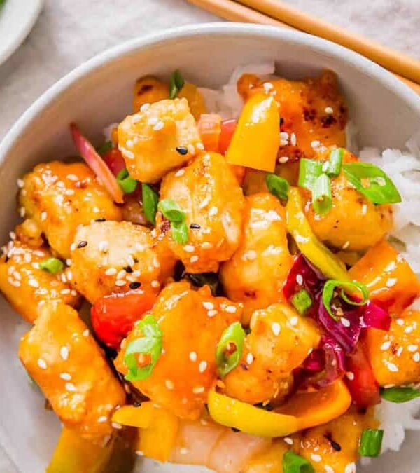 Chinese sweet and sour tofu stir fry in a bowl with chopsticks.