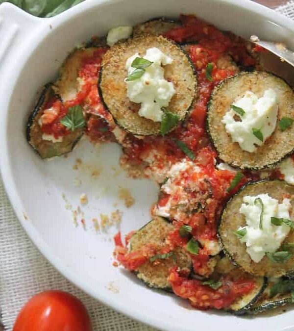 A dish of stuffed zucchini with tomatoes and ricotta cheese.
